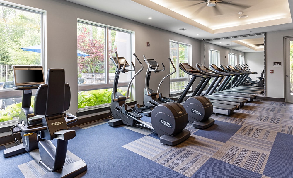 View of A luxury apartment fitness center with lots of cardio equipment