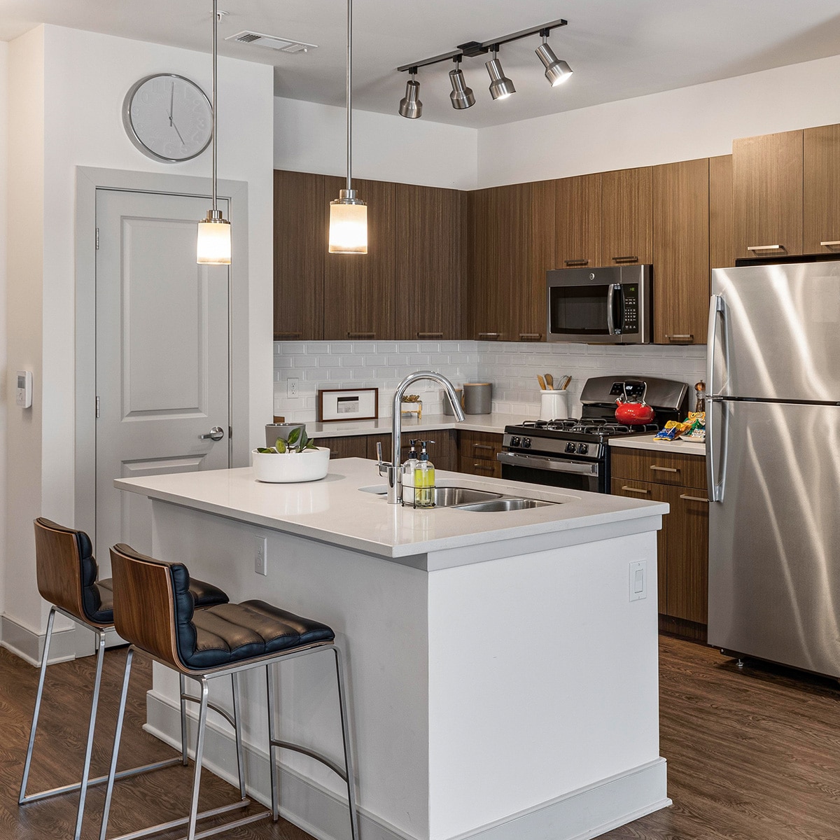 Deluxe apartment kitchen with stainless steel fridge and sink