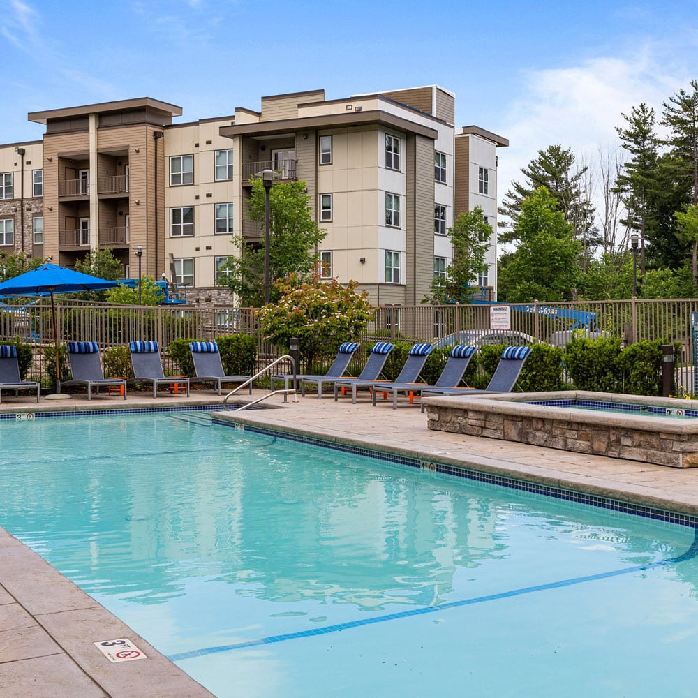 Pool side view of a nice apartment pool and hot tub